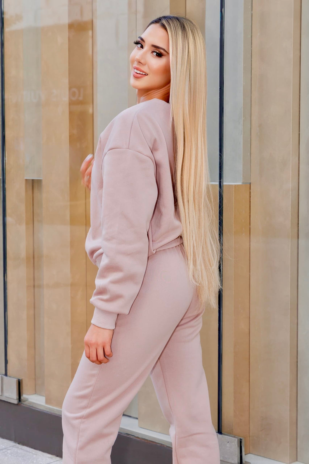 Woman wearing khaki 3-piece jogger set for "FLY IN STYLE" collection, showcasing chic and comfortable outfit.