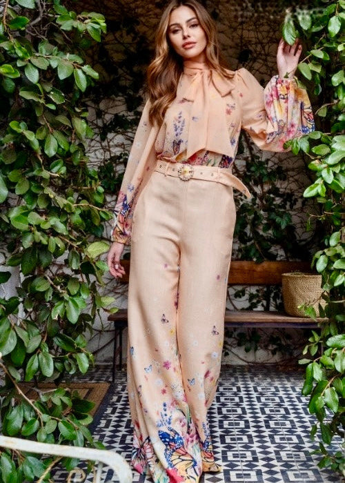 Elegant Lys three-piece set with butterfly print blouse, belt, and wide-leg pants in light beige.