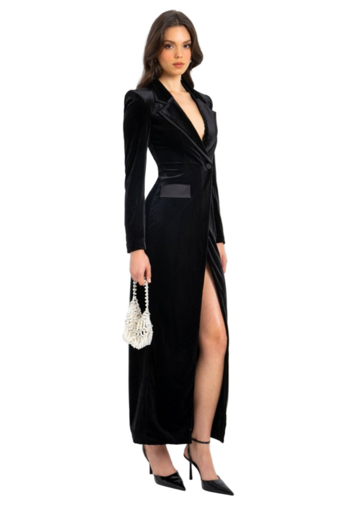 Black velvet high slit blazer gown on a model 