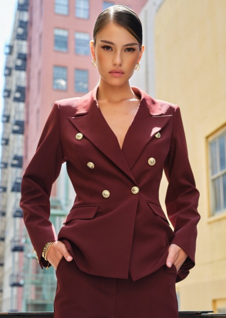 Burgundy blazer and pants combo with bold gold buttons, empowering outfit for professional women.