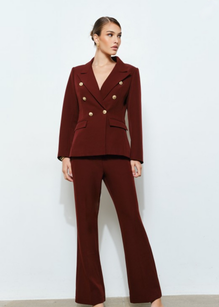 Stylish oxblood women’s pantsuit with gold button blazer, chic businesswear for leaders and entrepreneurs