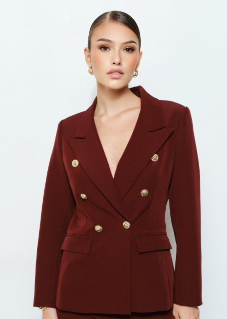  Trendy burgundy women’s suit with tailored fit, wide-leg pants, and gold button blazer, ideal for office wear