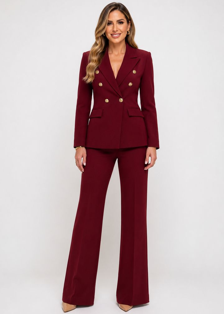 Elegant woman wearing the Burgundy Power Icon Two-Piece Suit Set with a tailored double-breasted blazer and wide-leg pants, front view.