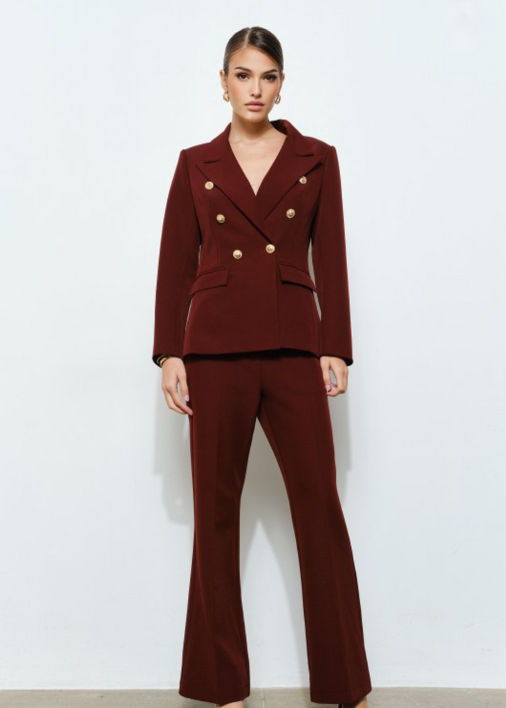Elegant burgundy two-piece suit with fitted blazer and wide-leg pants, luxury office attire.