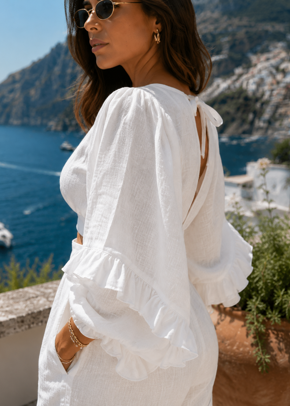 Close-up of The Capri Luxe White Linen Set showcasing premium linen fabric, elegant ruffle sleeves and refined craftsmanship.