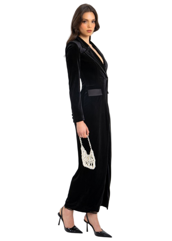 Woman wearing a black velvet high slit blazer gown on a shopping app interface.