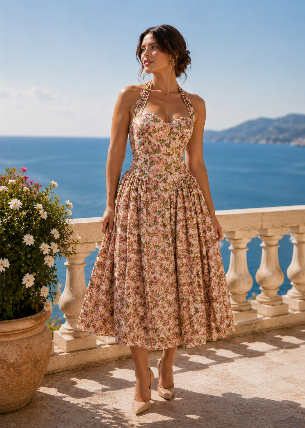 Woman wearing the Isabella Premium Floral Corset Midi Dress with beige stiletto heels on an elegant French Riviera terrace overlooking the Mediterranean Sea.