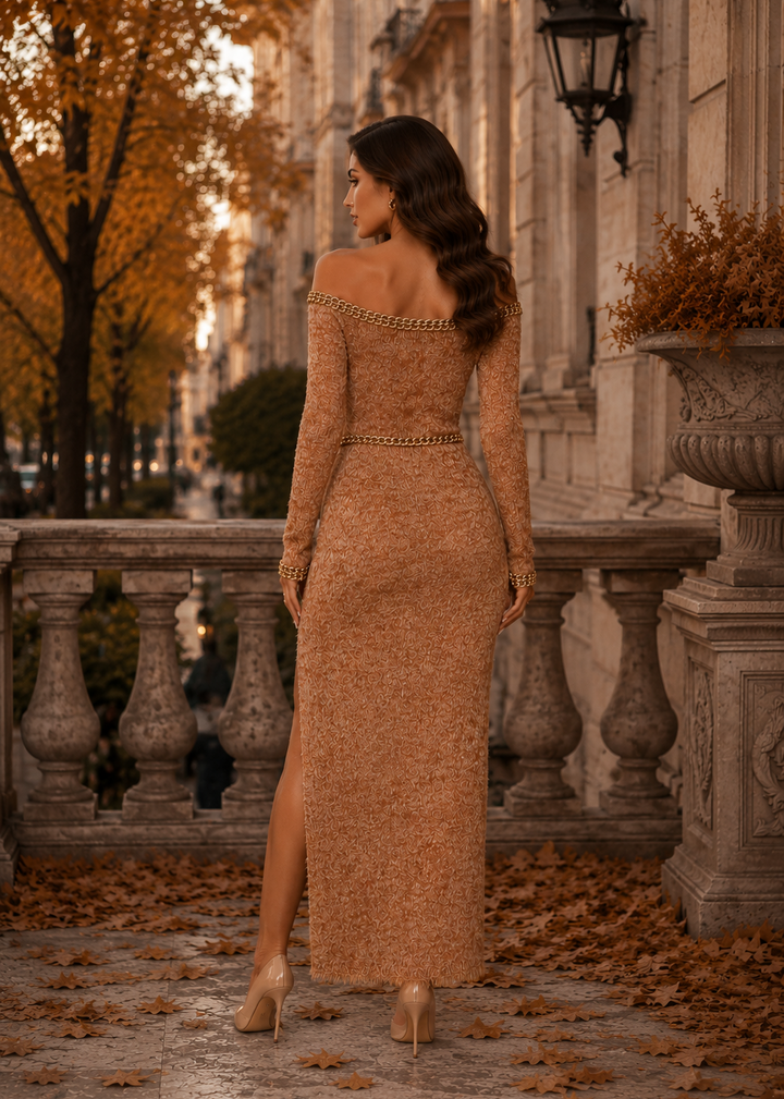 Back view of the Lisandra camel off shoulder sweater knit maxi dress featuring gold chain trim and elegant fitted silhouette.