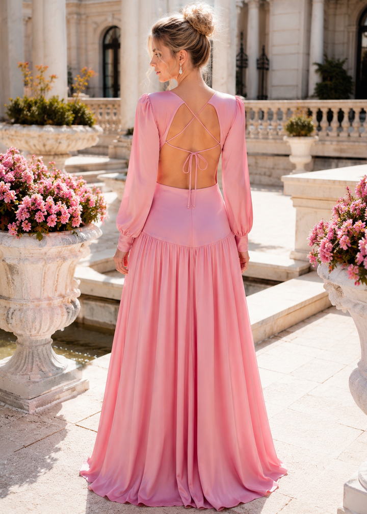 Back view of the Mykonos Pink Rose cutout long sleeve satin maxi dress featuring an elegant open back with adjustable tie detail in a luxury outdoor setting.