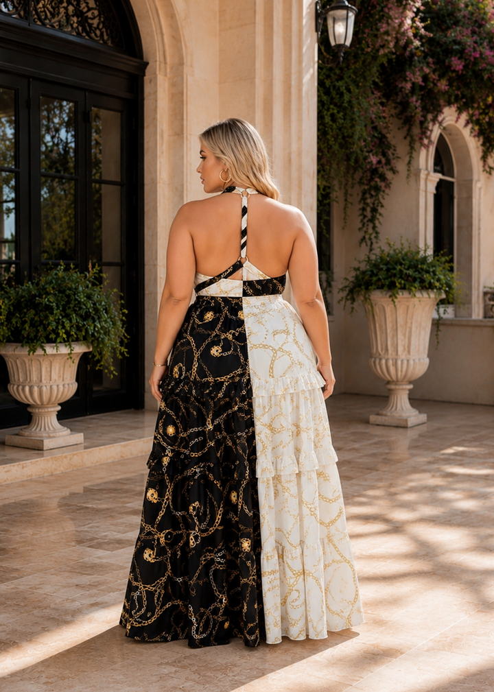 Back view of the NEW YORK black and white gold chain print plus size halter maxi dress featuring an elegant open-back design and tiered ruffle skirt.
