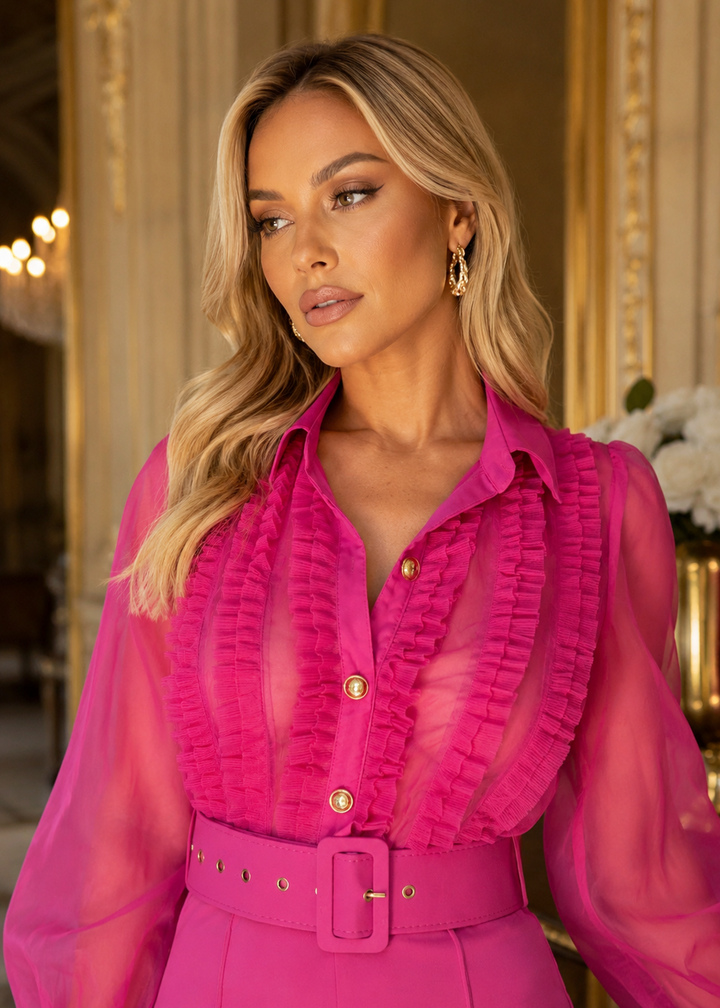 Close-up of the Norma Pink Organza Jumpsuit highlighting the sheer organza blouse, romantic ruffle details, gold buttons and matching belt.