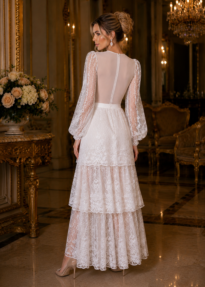 Woman wearing the ODETTE White 2-Piece Lace Body Suit &amp; Skirt at an elegant outdoor evening reception featuring a lakeside estate, white décor, and refined lace details.