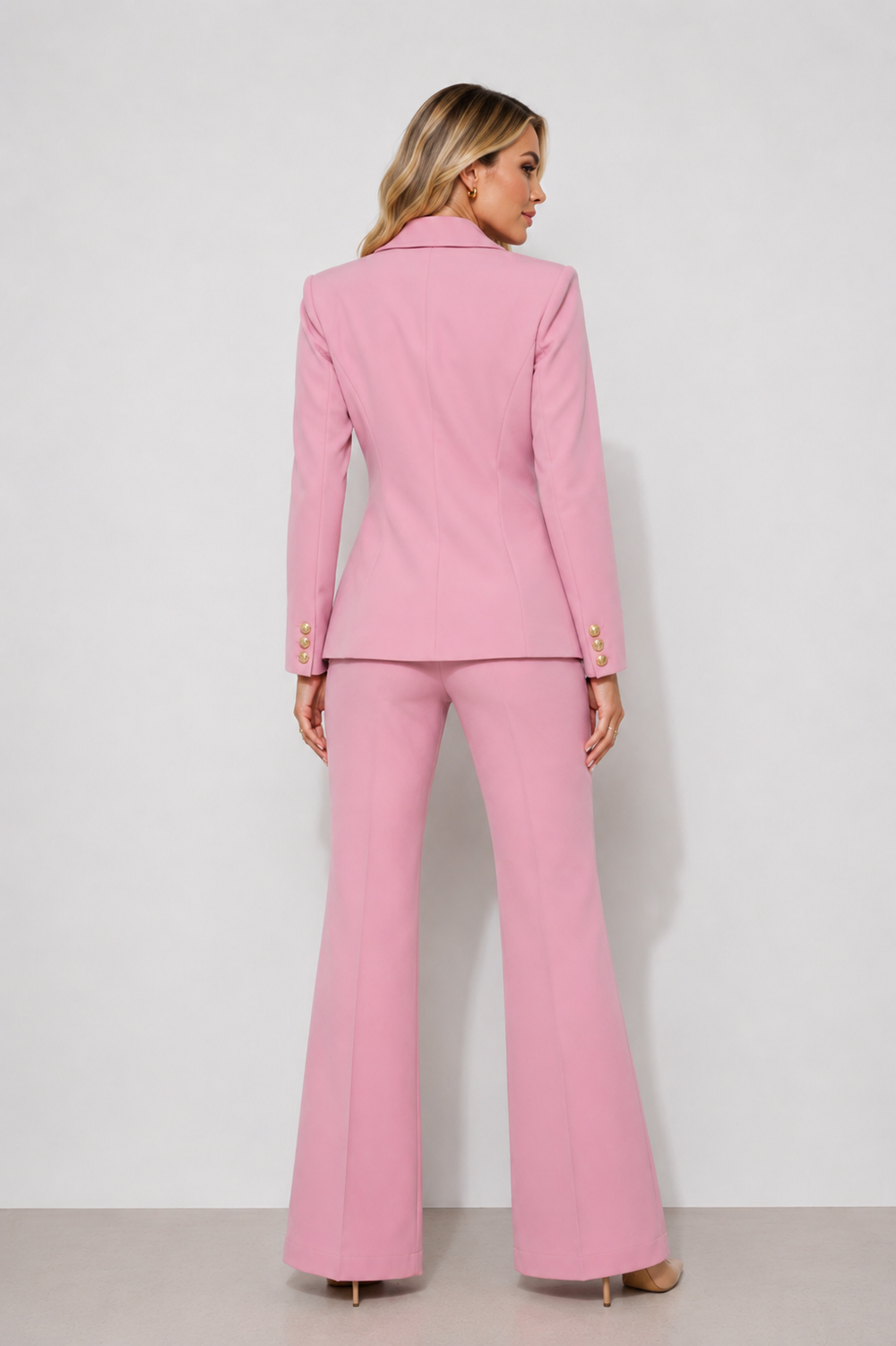 Elegant women’s pink three-piece suit with gold buttons, tailored blazer, matching vest, and dress pants for business meetings, events, and professional wear.