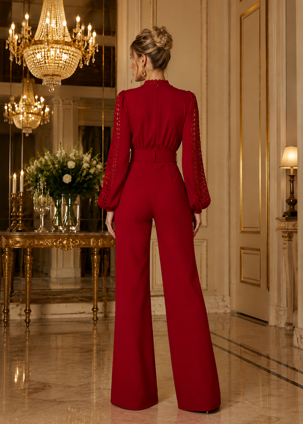 Luxury red wide-leg jumpsuit featuring crochet lace sleeves, high neckline, statement belt and elegant tailored fit for women.