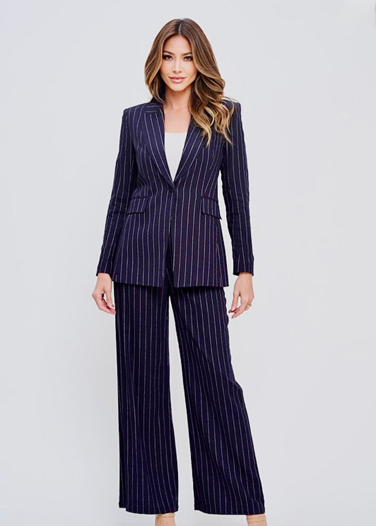 Businesswoman dressed in a navy pinstripe 3-piece executive suit with blazer, wide-leg pants, and white blouse – chic office and networking event outfit