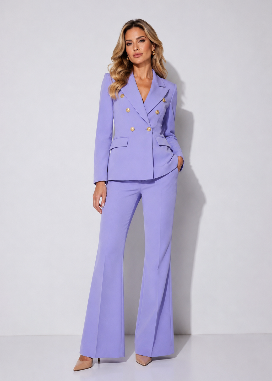 Elegant woman wearing the Lavender Grace Icon Two-Piece Suit featuring a tailored lavender blazer with gold buttons and matching wide-leg trousers.