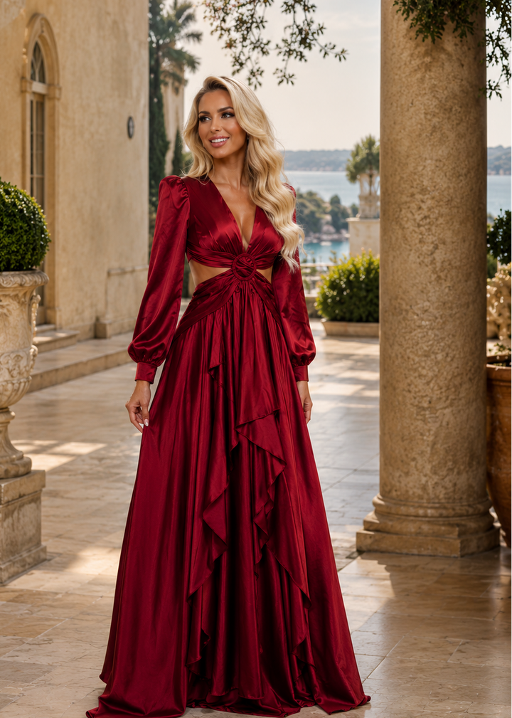 Woman wearing the Mykonos Red Ruby Satin Maxi Dress featuring luxurious satin fabric, elegant long sleeves, open-back design and flowing silhouette for weddings and formal occasions.
