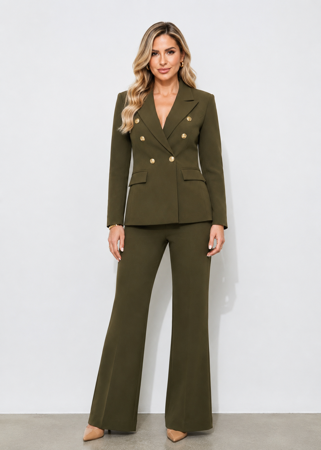 Elegant woman wearing the Olive Prestige Icon Two-Piece Suit featuring a tailored olive green blazer with gold buttons and matching wide-leg trousers.